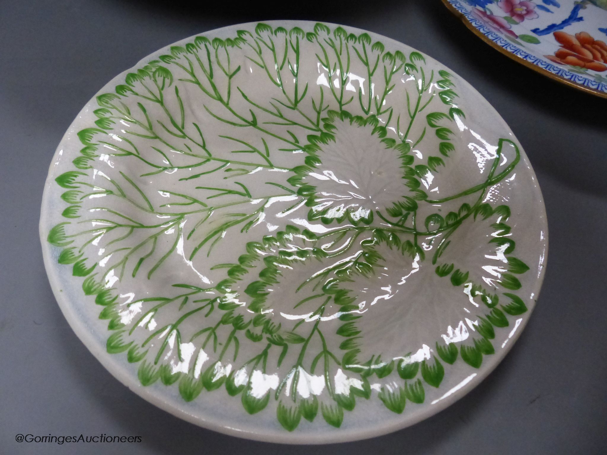A Moroccan terracotta dish, an Ironstone dish, a green and white leaf dish, largest 30cm